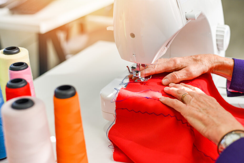 Senior woman tailor working at the sewing factory - Seamstress d